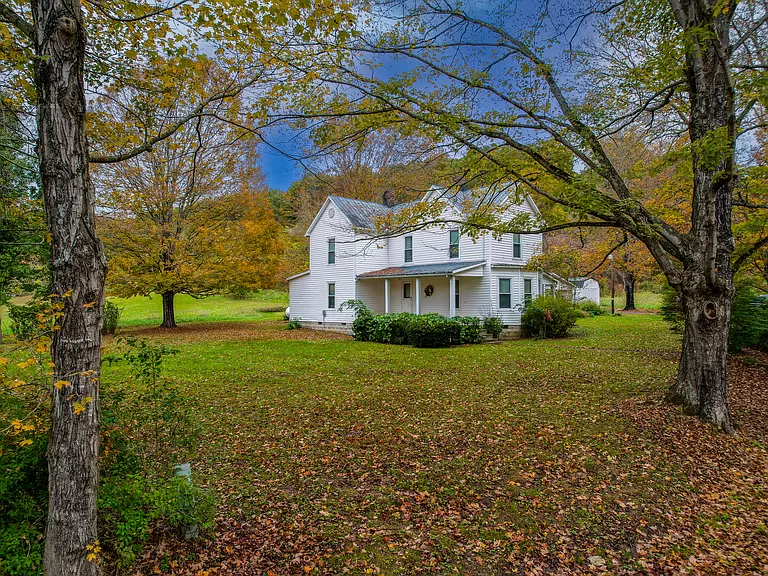 Discover this hidden homestead, a Kentucky farmhouse for sale with a picturesque retreat on 23 acres.