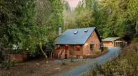 Your private Washington cabins for sale: 5-Bedroom Log Cabin with Year-Round Creek and Gourmet Kitchen.