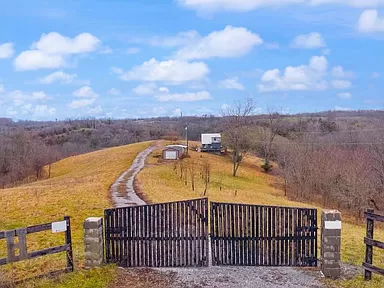 Charming Kentucky farmhouse for sale—discover this 3-bedroom home on 15.20 acres perfect for farmland.