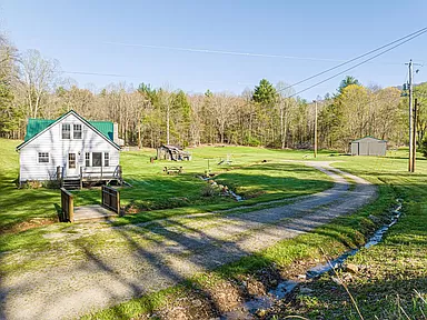 Charming Virginia farmhouse for sale, 3-Bedroom Homestead on 24 Acres with Creek and Barns.