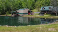 charming Kentucky cabins for sale, homestead on a 12-acre lot with a stocked pond.