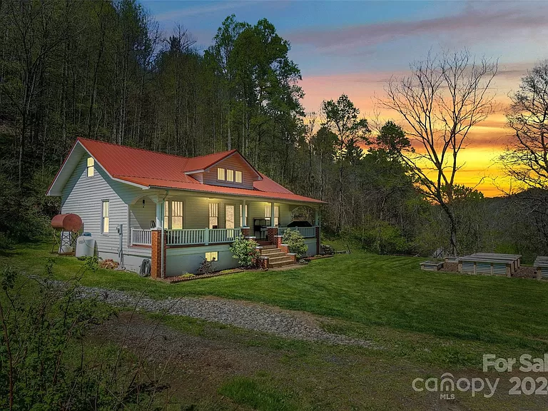 Charming North Carolina farmhouses for sale: This beautiful mountain farmhouse spans 7 acres.