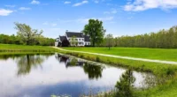 Charming Virginia farmhouse for sale. Discover this 27-acre farm with a pond and pastoral land.