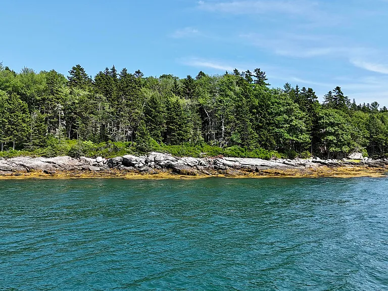 This charming Maine waterfront property is for sale on a 33-acre lot.